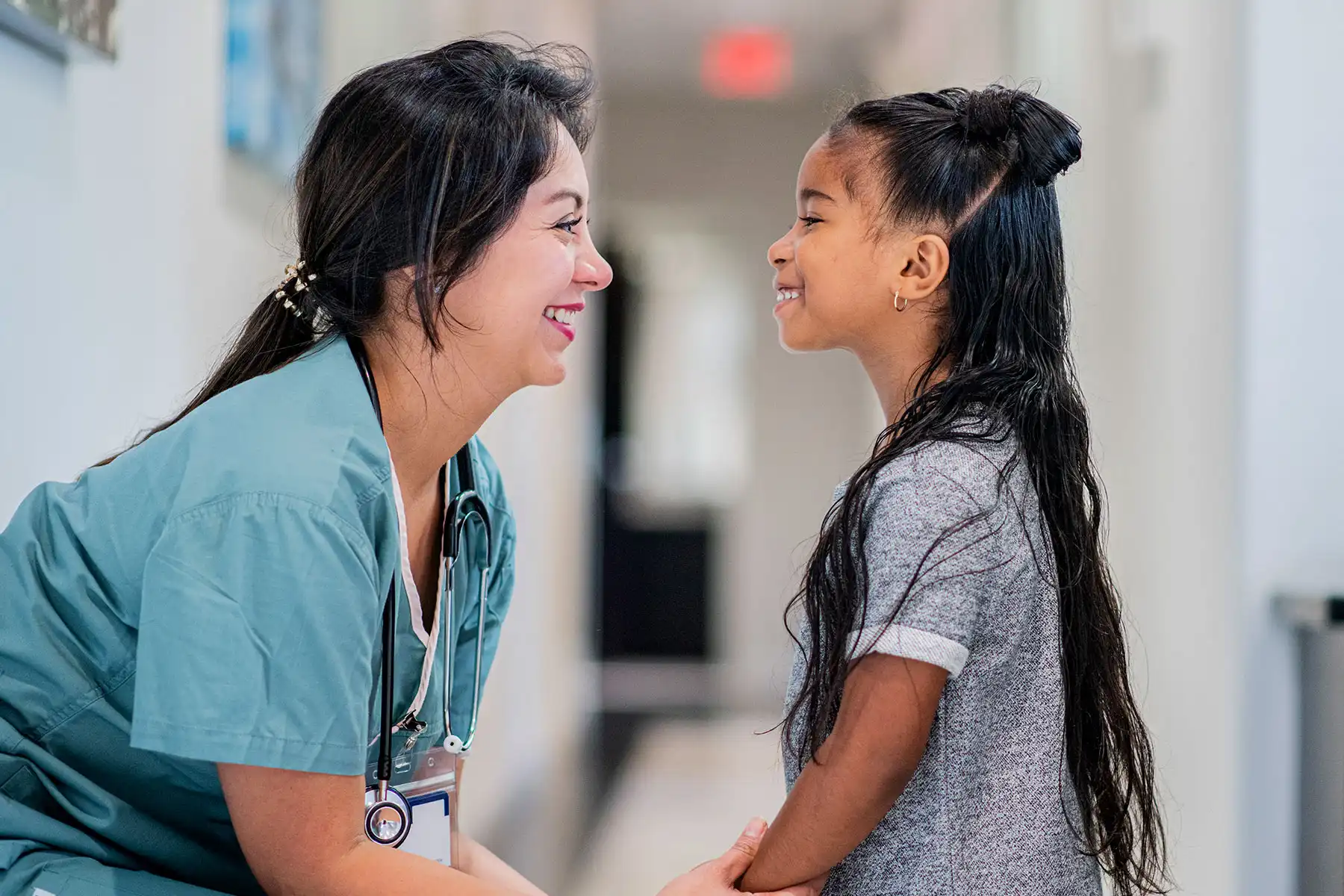 photo of pediatrician talking to girl