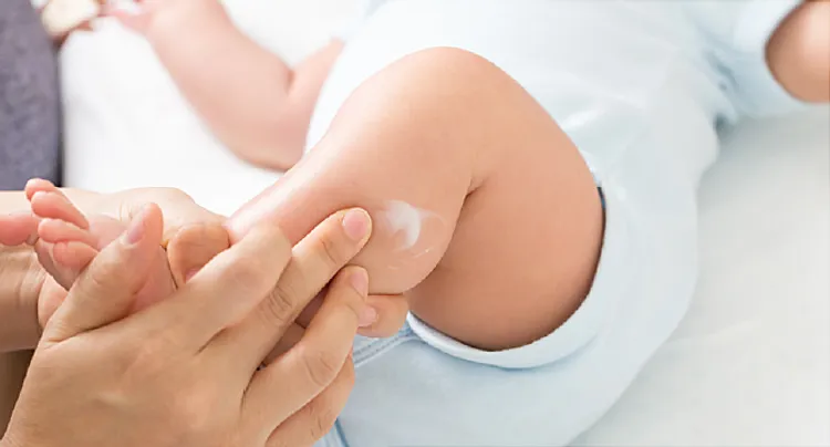 photo of applying lotion to baby's leg