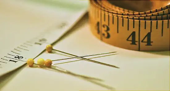 measuring tape and pins