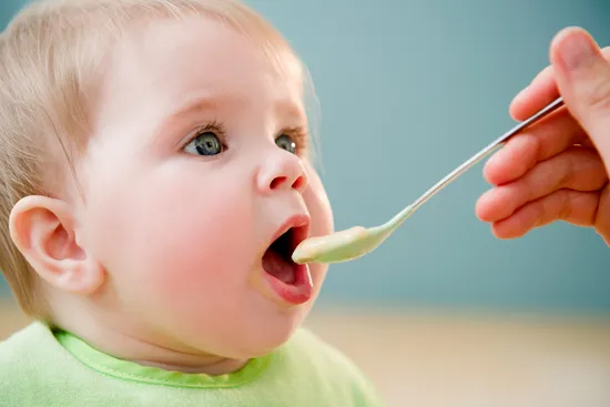 feeding baby with spoon