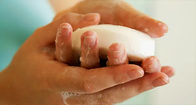 Young Woman Washing Hands with Bar of Soap