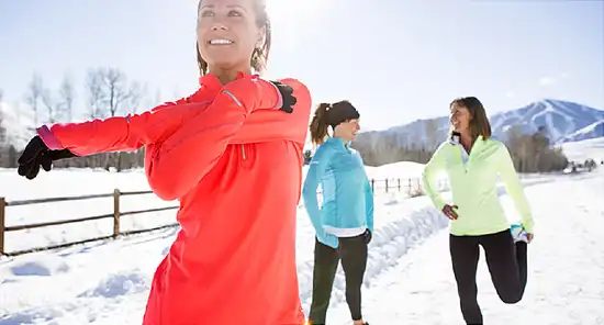 women preparing to exercise in snow