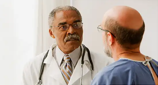 African doctor talking to patient