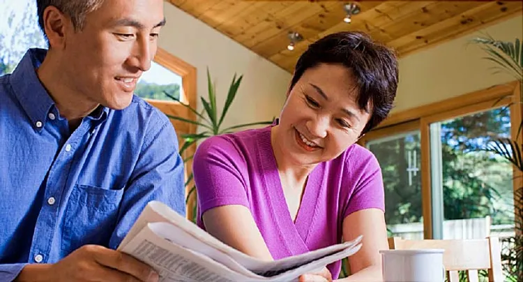 mature couple reading paper