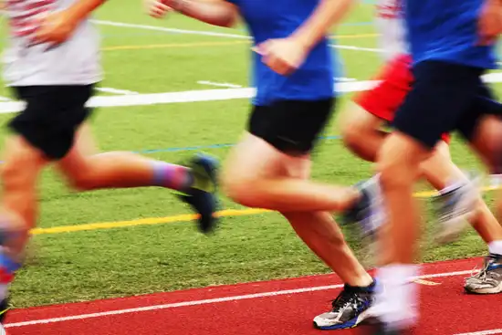 photo of casual runners on track blurred