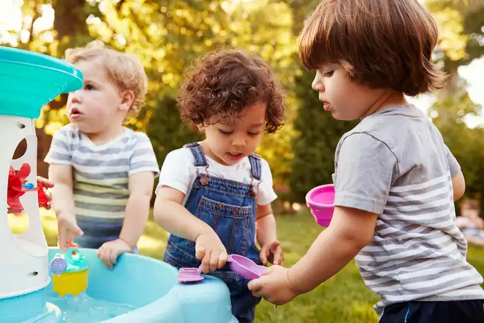 photo of young children playing with water table
