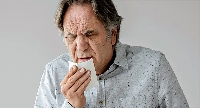 photo of mature man coughing