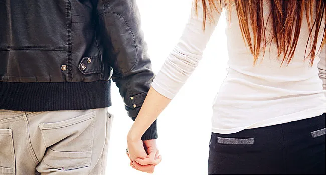 teen couple holding hands