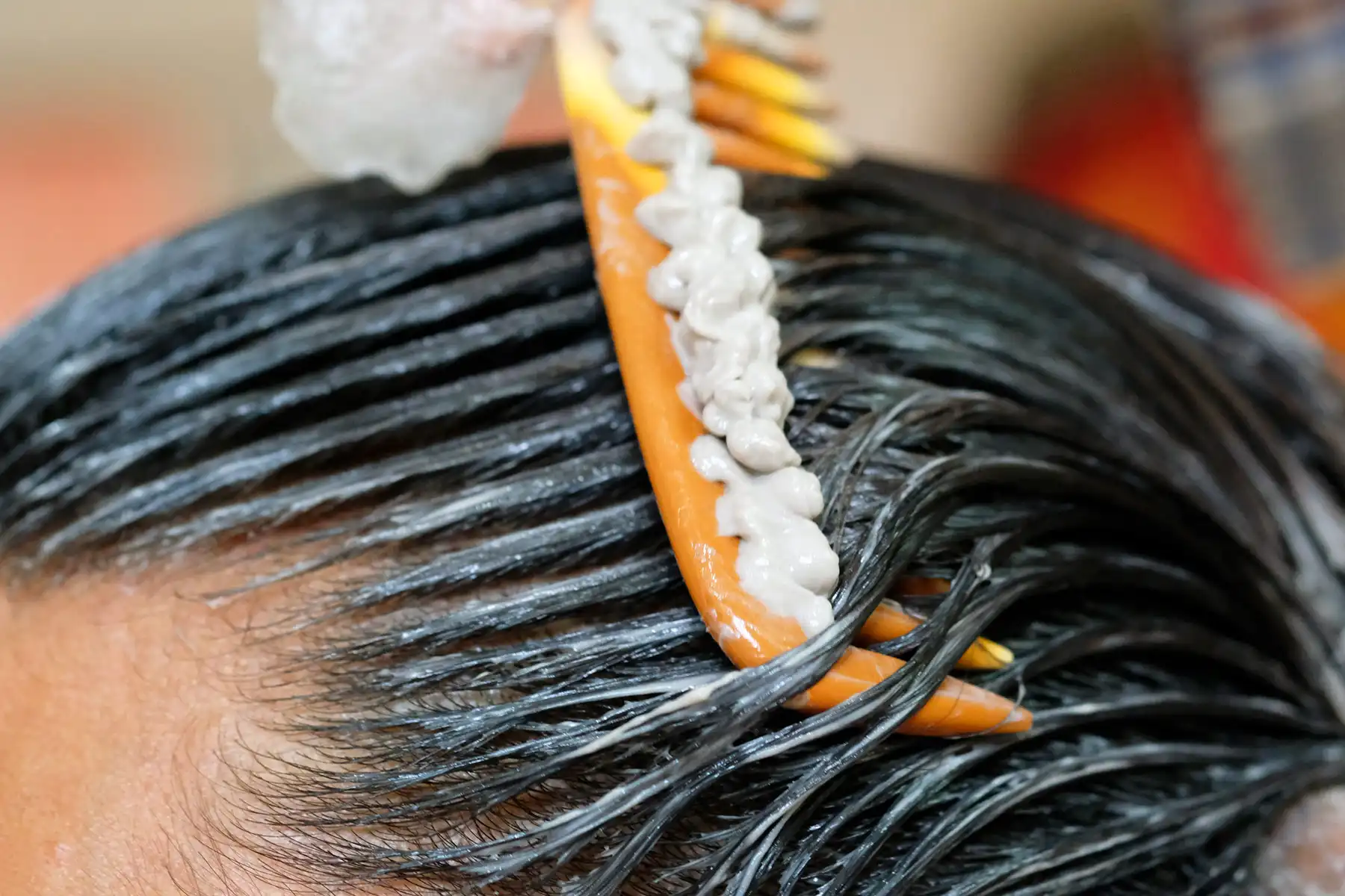 photo of combing treatment cream rhrough hair
