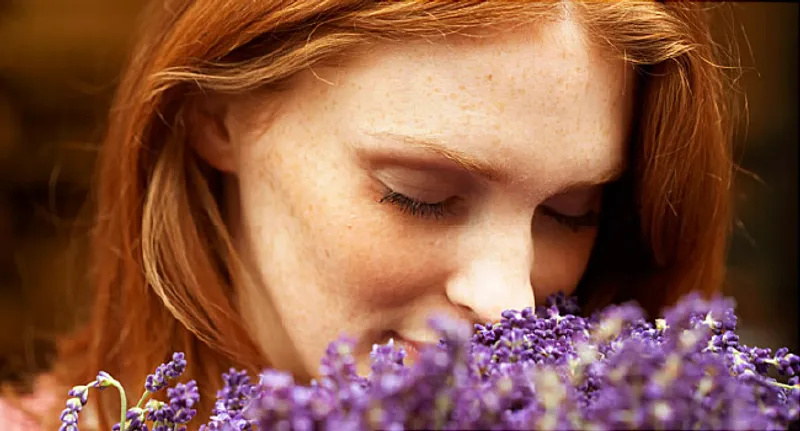 Young woman smelling lavendar