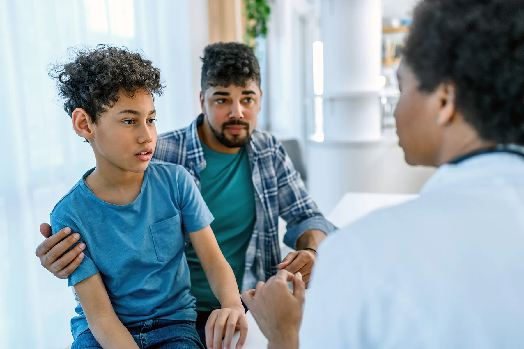 photo of doctor talking with father and son