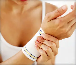 woman putting on wrist support