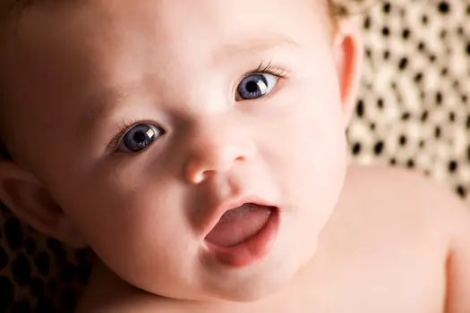photo of close up of baby face with mouth open