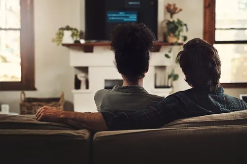 photo of couple watching tv together