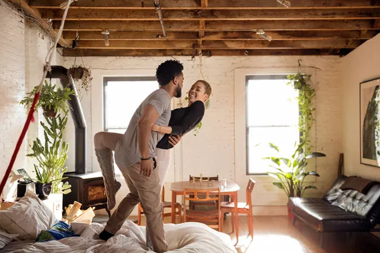 photo of couple dancing on the bed