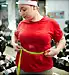 woman measuring waist in gym