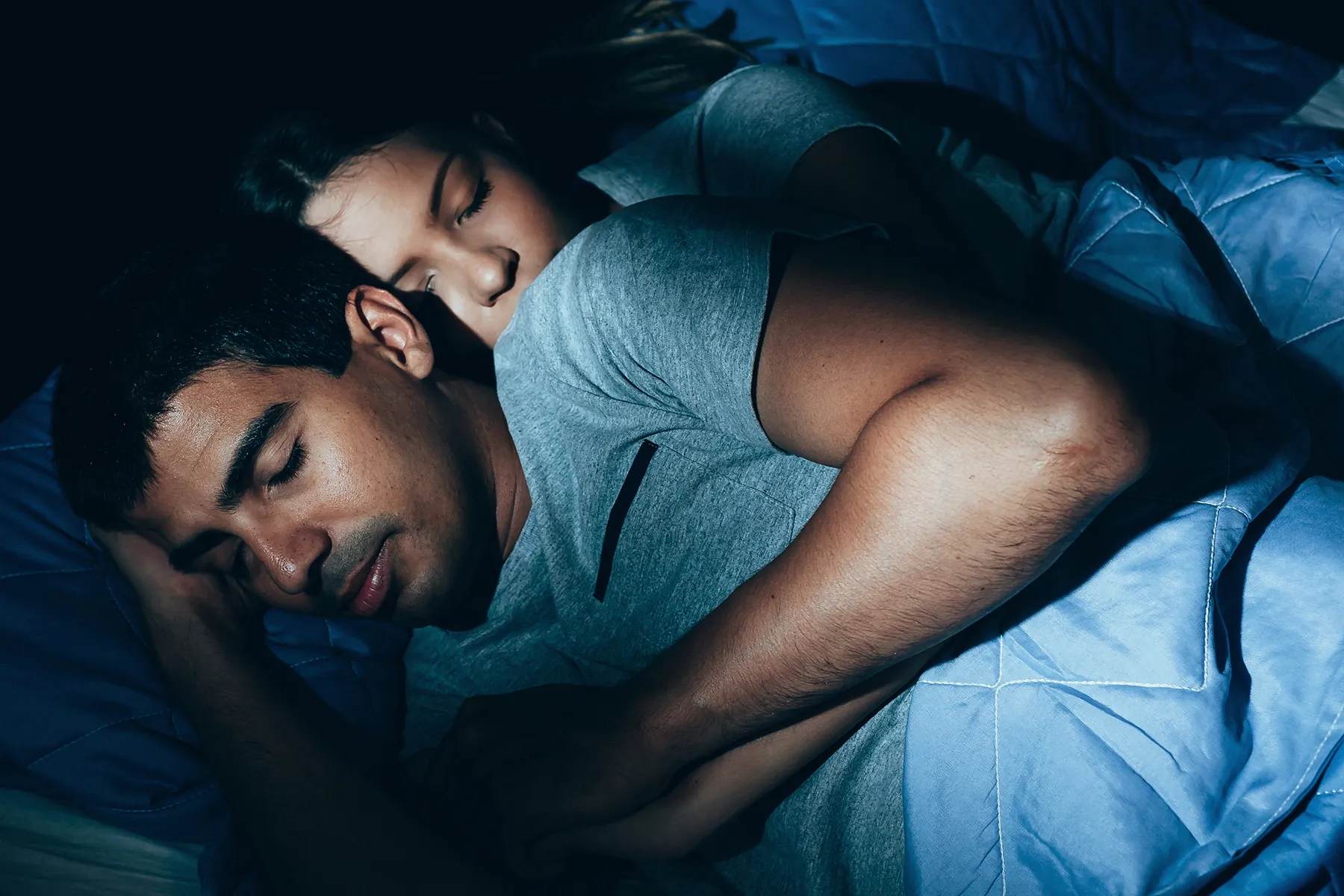 photo of couple sleeping in dark room