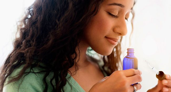 photo of woman smelling essential oils