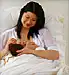 Chinese mother breast feeding newborn baby girl