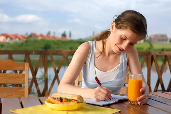 photo of woman writing in food diary