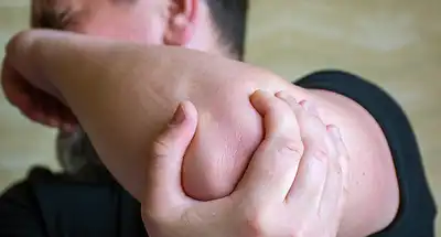 photo of man holding elbow