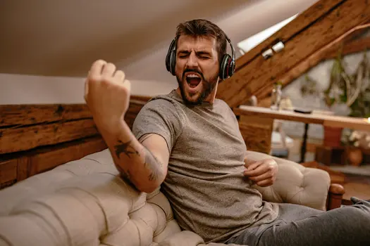 photo of man rocking out to music