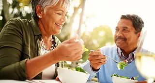 mature couple eating salad