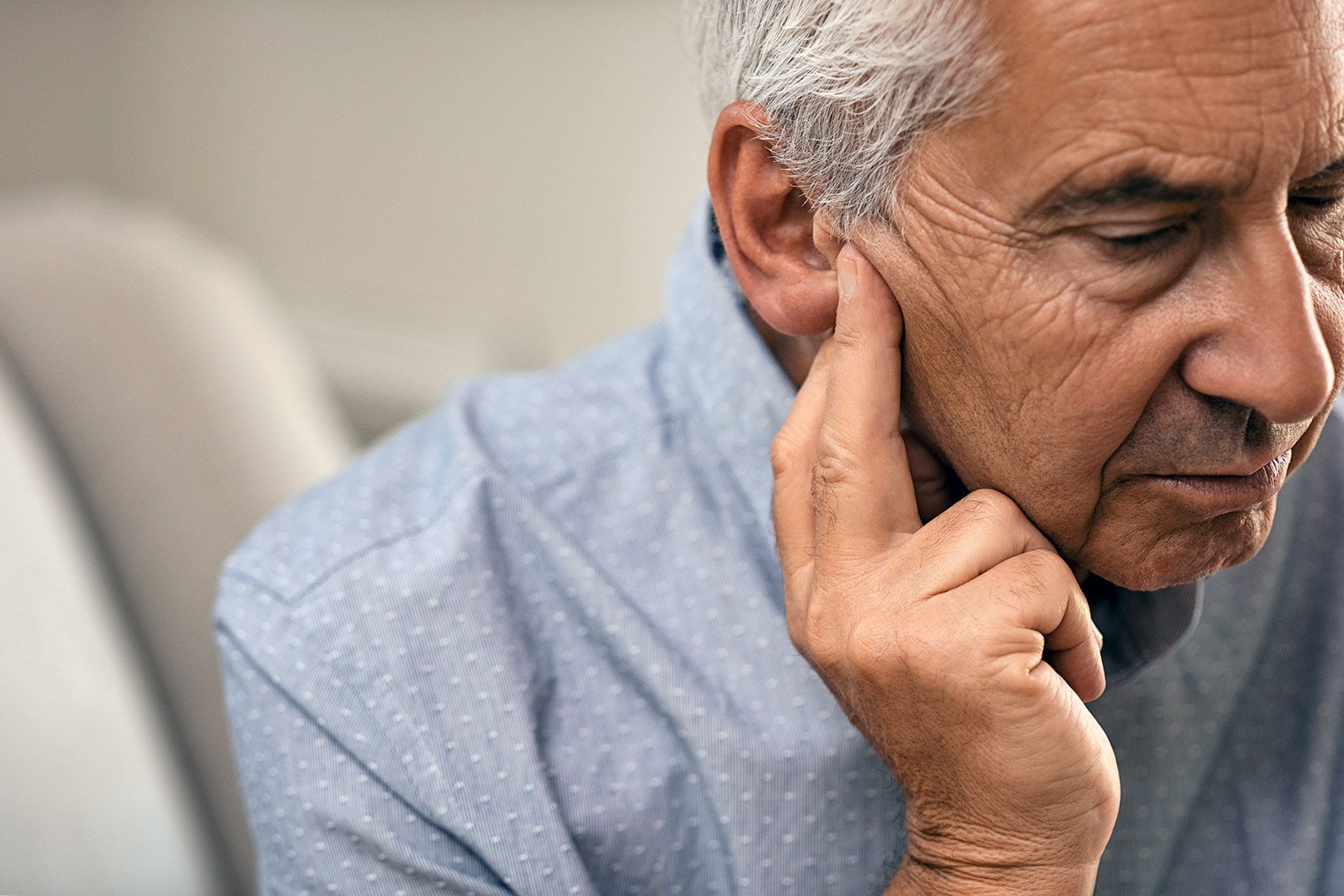 photo of senior man experiencing hearing loss