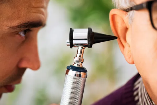 photo of doctor examining patient ear
