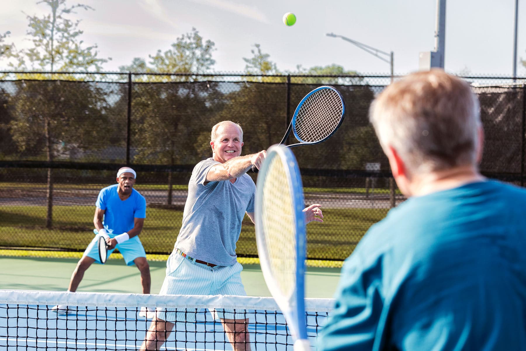photo of mature men playing tennis