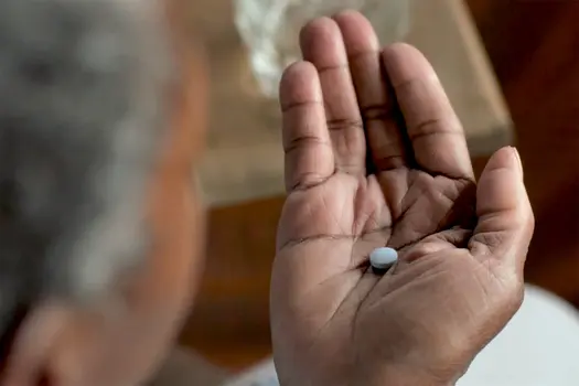 photo of woman taking pill