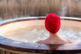 photo of woman relaxing in hot tub