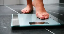 foot stepping on scale
