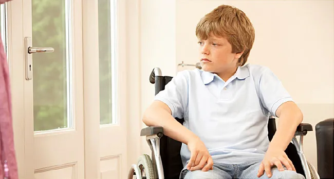 child sitting in wheelchair