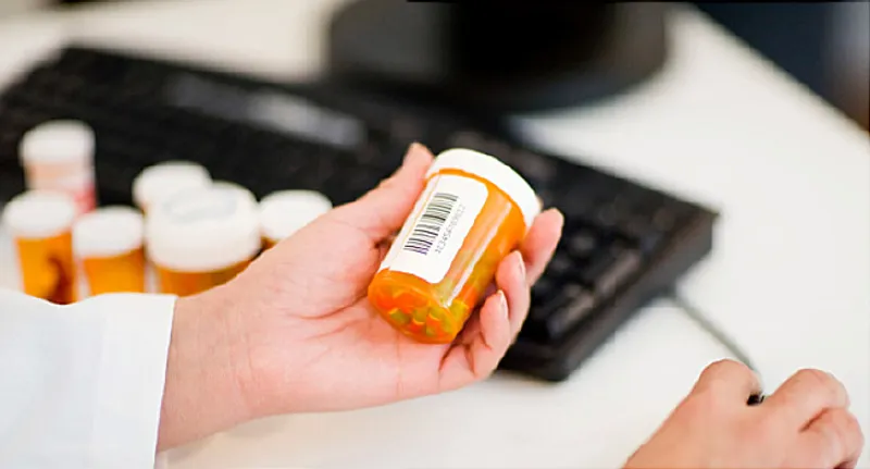 pharmacist with pill bottle