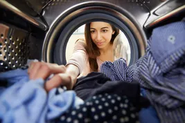 photo of woman doing laundry