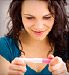 woman reading pregnancy test result