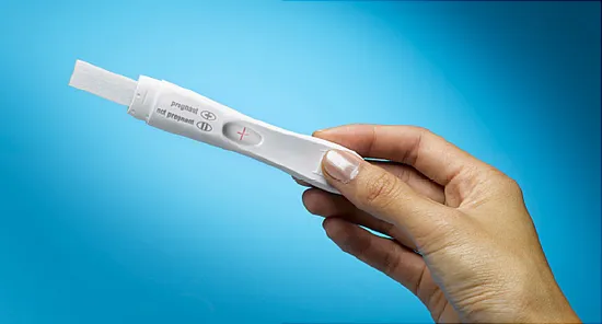 hand holding pregnancy testhand holding pregnancy test
