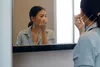 photo of woman putting on make up
