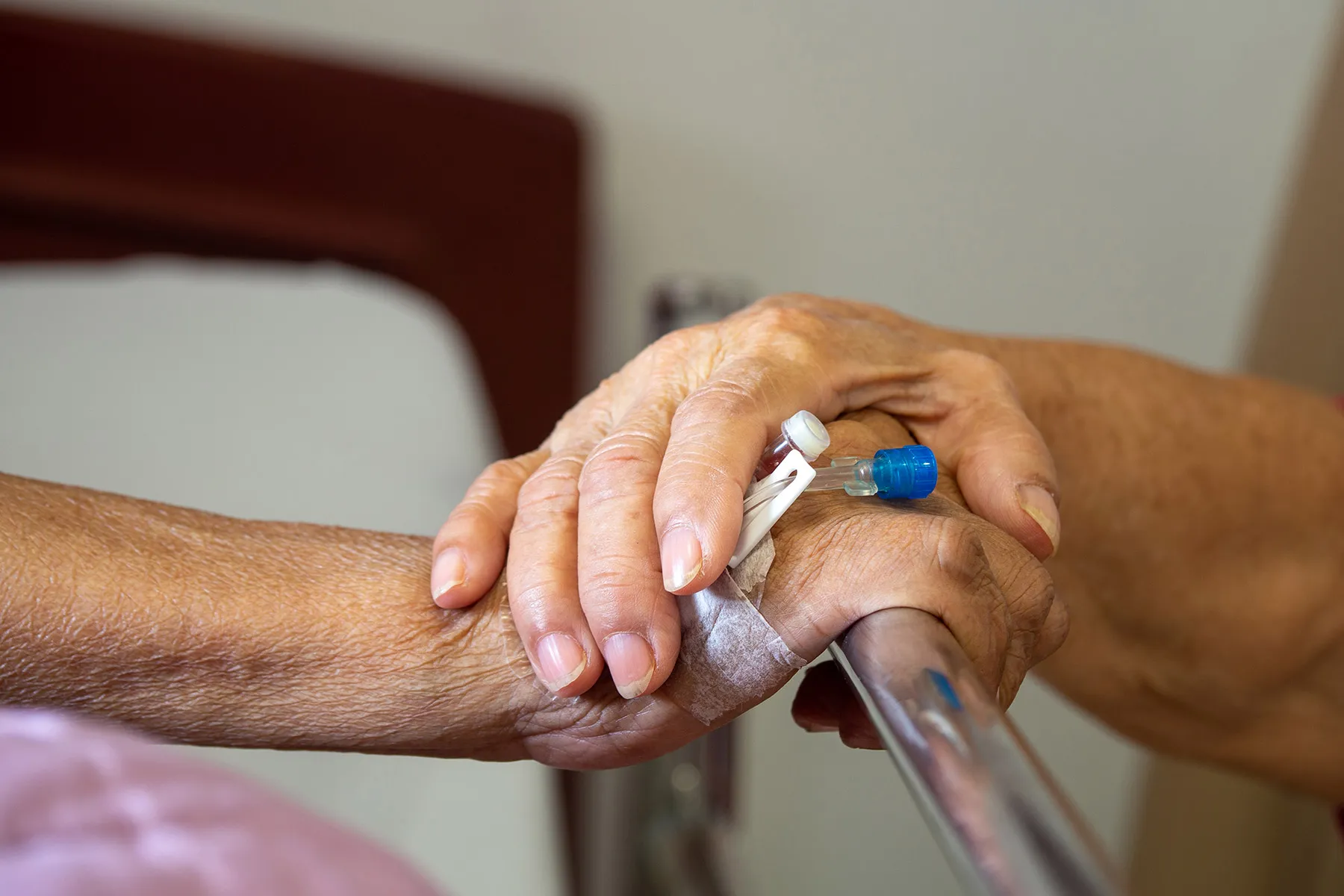 caregiver holding hand of patientcaregiver holding