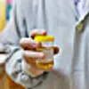 doctor holds bottle of urine test