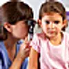 doctor checking girls ear