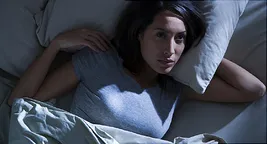 woman lying awake in bed