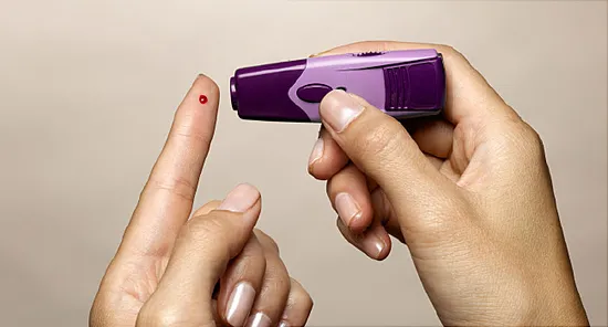 woman using diabetes test kit