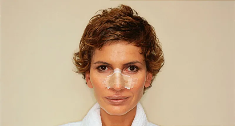 woman with bandage on nose