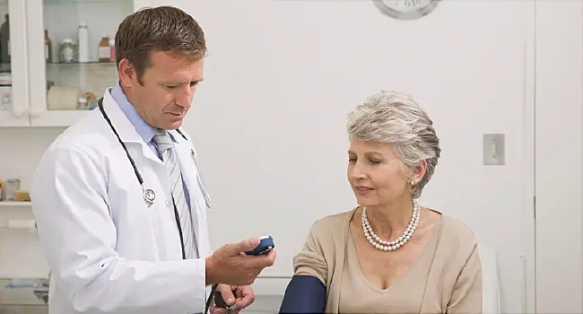 doctor examining blood pressure of patient