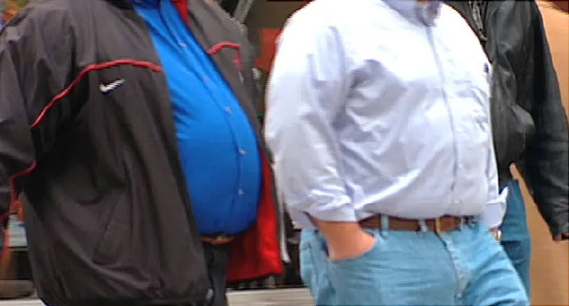 obese people walking in an airport