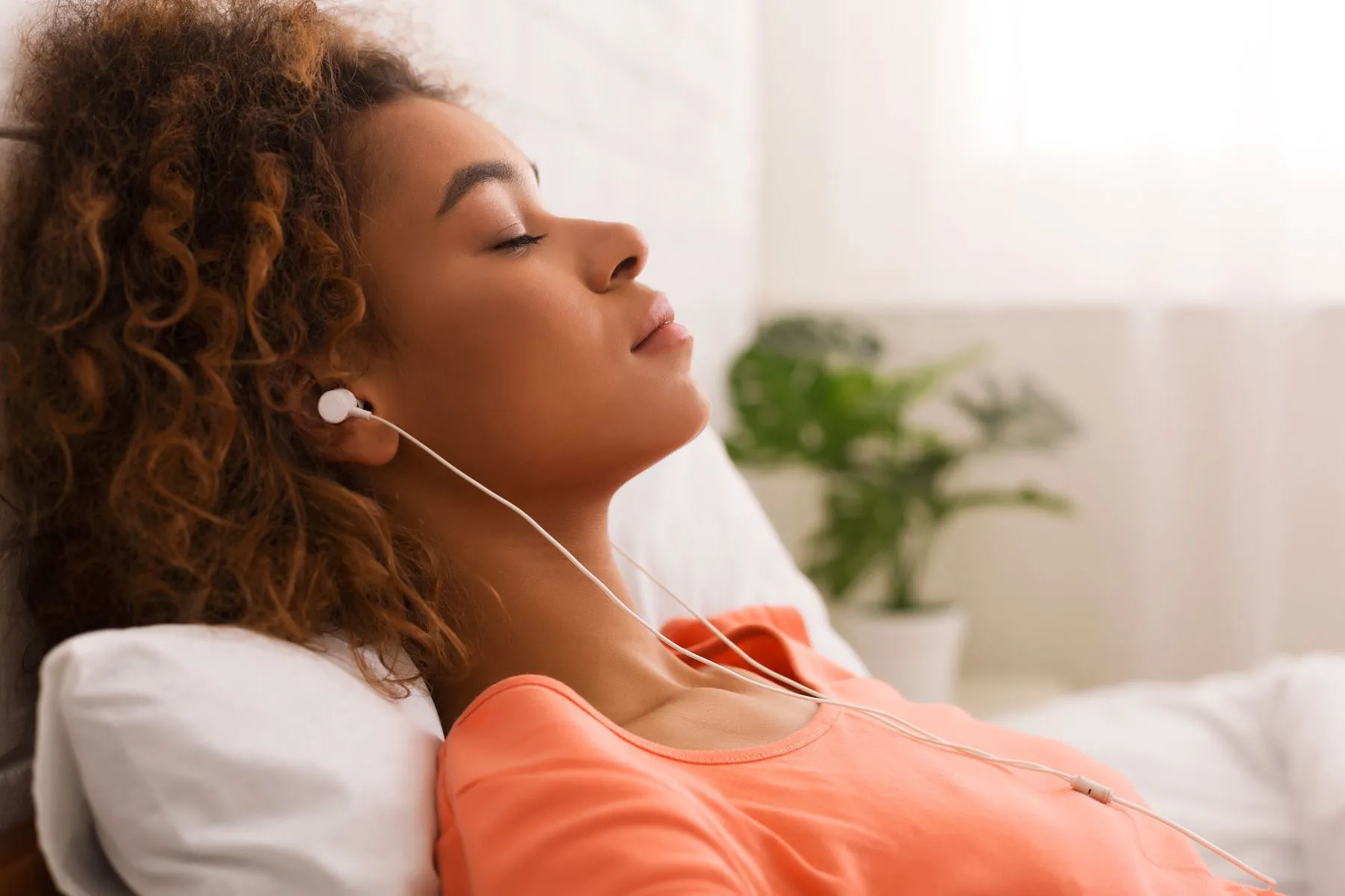 photo of woman relaxing listening to music