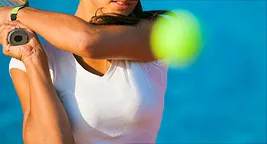 woman hitting tennis ball