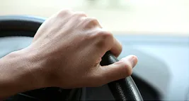 hand on steering wheel